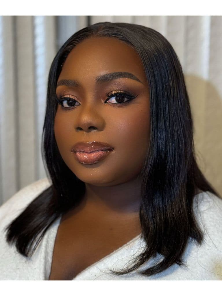 Bronze glitter cut-crease with a glossy brown-lined lip